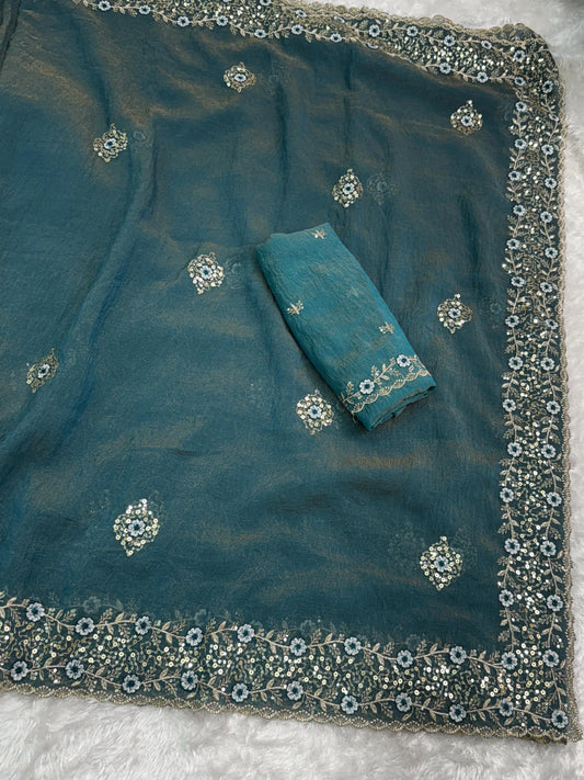 Golden tissue saree with delicate embroidery, showcasing a lightweight and glossy fabric perfect for festive wear.