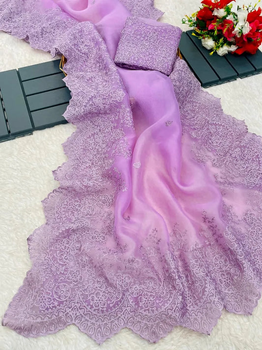 Lavender organza saree with embroidered blouse design featuring intricate lacework and floral garden backdrop