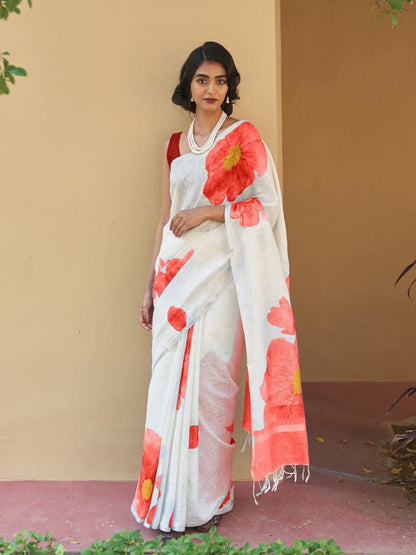 Beautiful woman wearing a white linen digital print saree with Red floral design