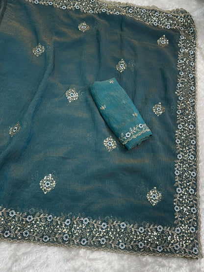 Golden tissue saree with delicate embroidery, showcasing a lightweight and glossy fabric perfect for festive wear.