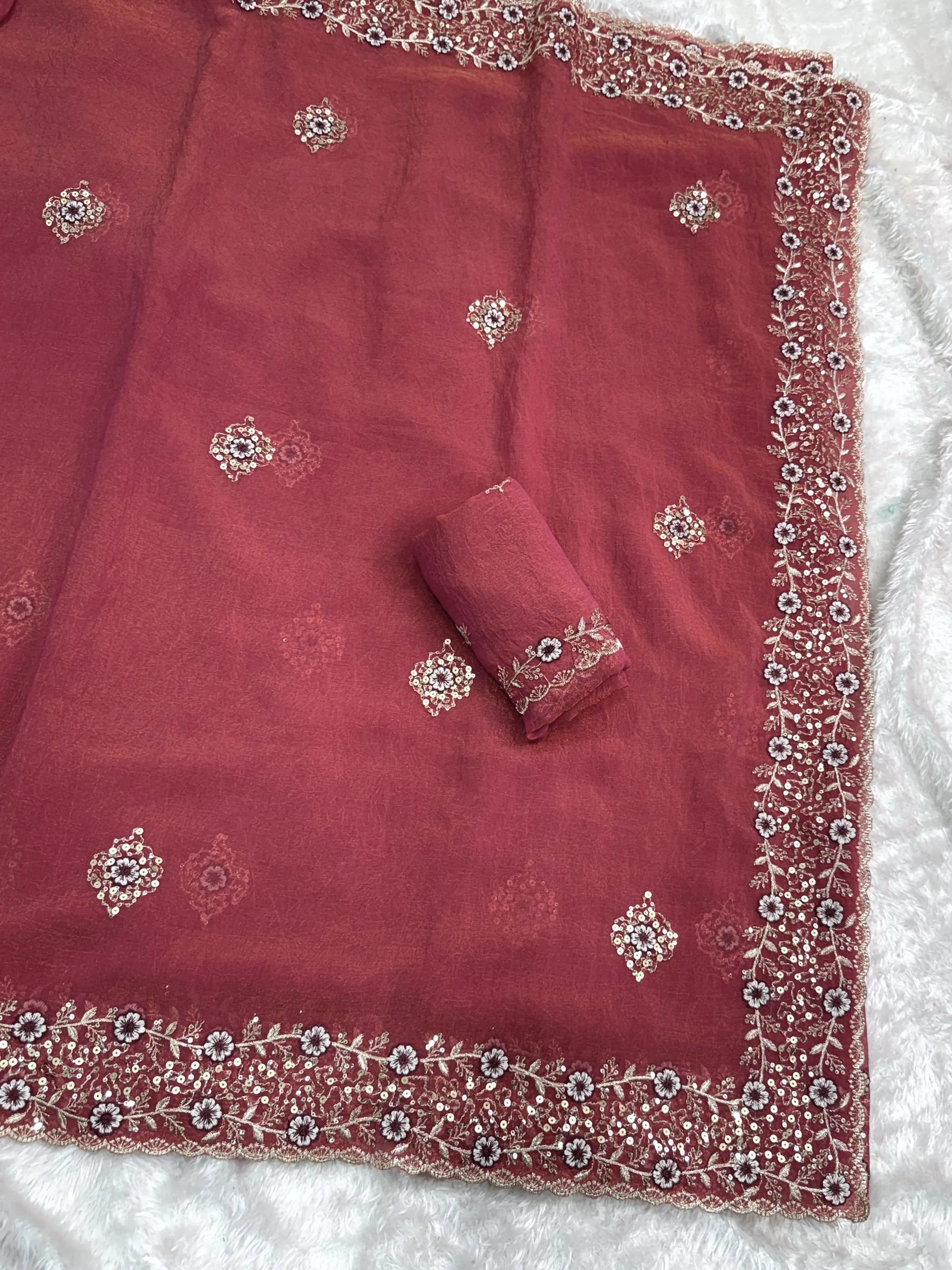 Shimmering tissue saree with intricate detailing, offering a lightweight and elegant look for special occasions.
