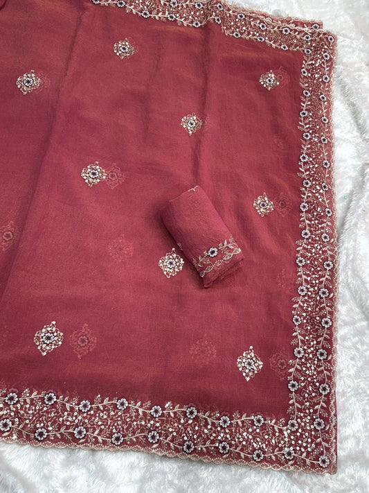 Shimmering tissue saree with intricate detailing, offering a lightweight and elegant look for special occasions.