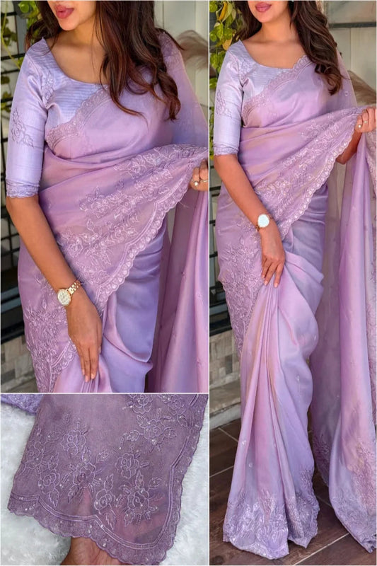 Elegant cream embroidered saree with floral lace border, paired with magenta blouse, ideal for festive and traditional occasions.
