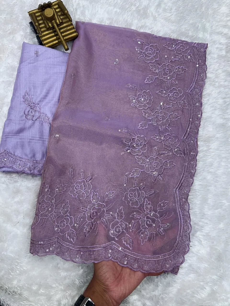 Elegant cream embroidered saree with floral lace border, paired with magenta blouse, ideal for festive and traditional occasions.