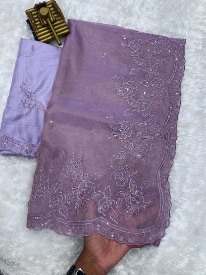 Elegant cream embroidered saree with floral lace border, paired with magenta blouse, ideal for festive and traditional occasions.