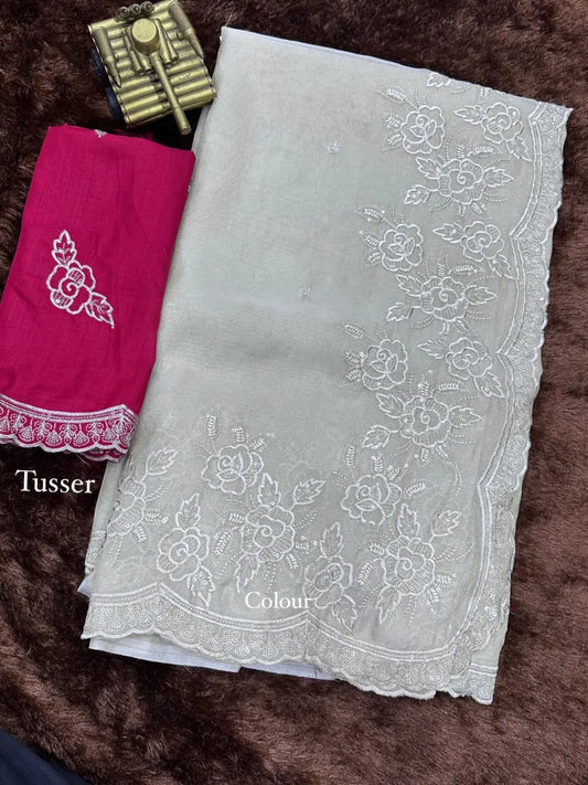 Elegant cream embroidered saree with floral lace border, paired with magenta blouse, ideal for festive and traditional occasions.
