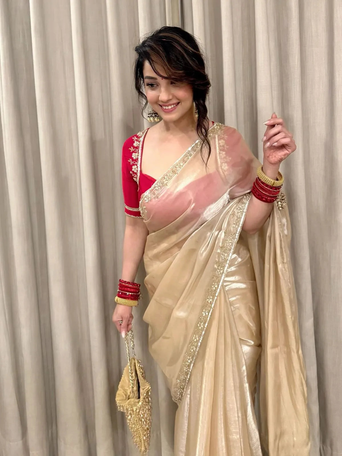 Golden beige party wear saree with embroidered red blouse and shimmer fabric for wedding and festive occasions
