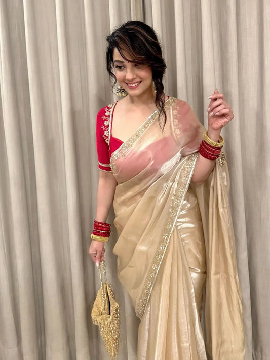 Golden beige party wear saree with embroidered red blouse and shimmer fabric for wedding and festive occasions