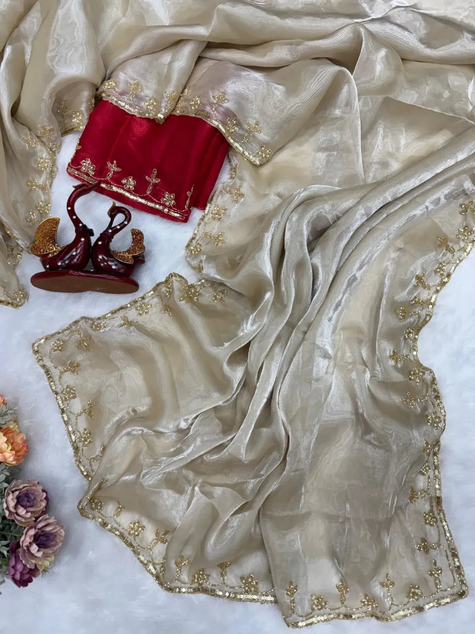 Golden beige party wear saree with embroidered red blouse and shimmer fabric for wedding and festive occasions