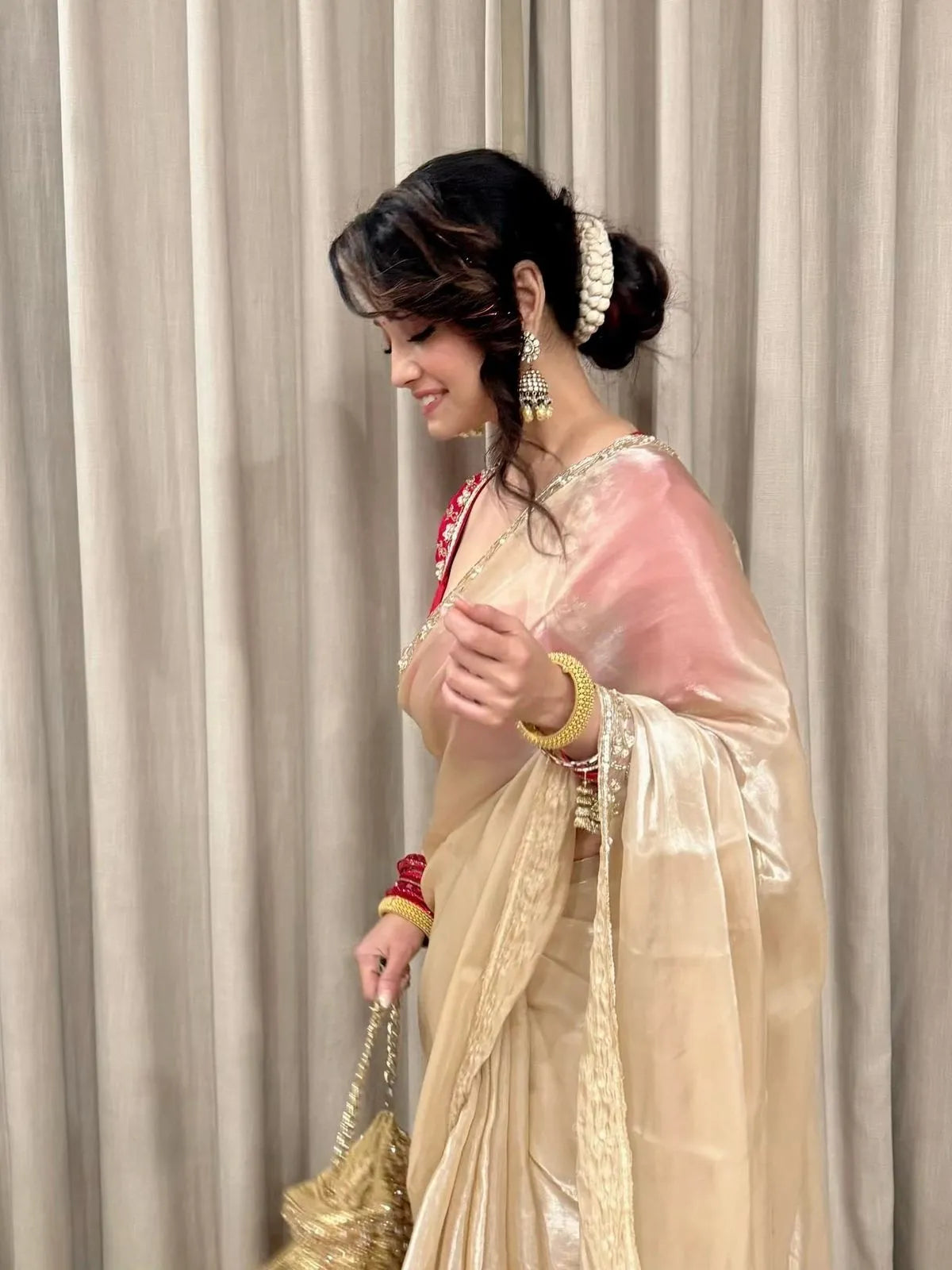 Golden beige party wear saree with embroidered red blouse and shimmer fabric for wedding and festive occasions