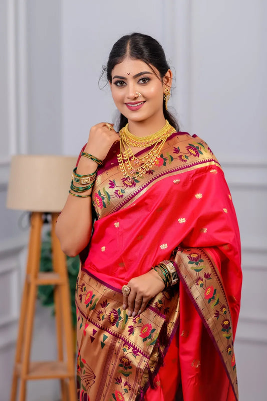 Traditional paithani saree look in bright red-pink silk with golden tissue border, colorful floral motifs, styled with gold jewelry