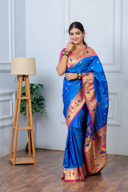 Woman wearing royal blue Paithani saree with golden zari border and pink blouse in traditional Indian style