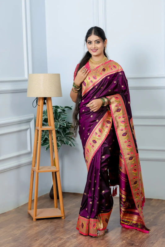 Close-up paithani saree look featuring wine purple handwoven silk with golden tissue border and multi-layered gold necklace styling