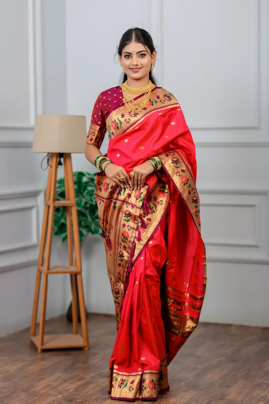 Traditional paithani saree look in bright red-pink silk with golden tissue border, colorful floral motifs, styled with gold jewelry