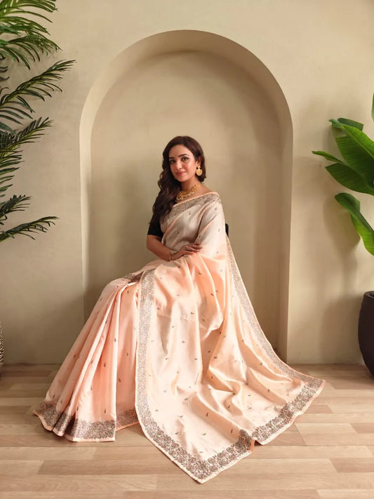 Woman wearing peach tussar saree with sequin border and black blouse in contemporary Indian style