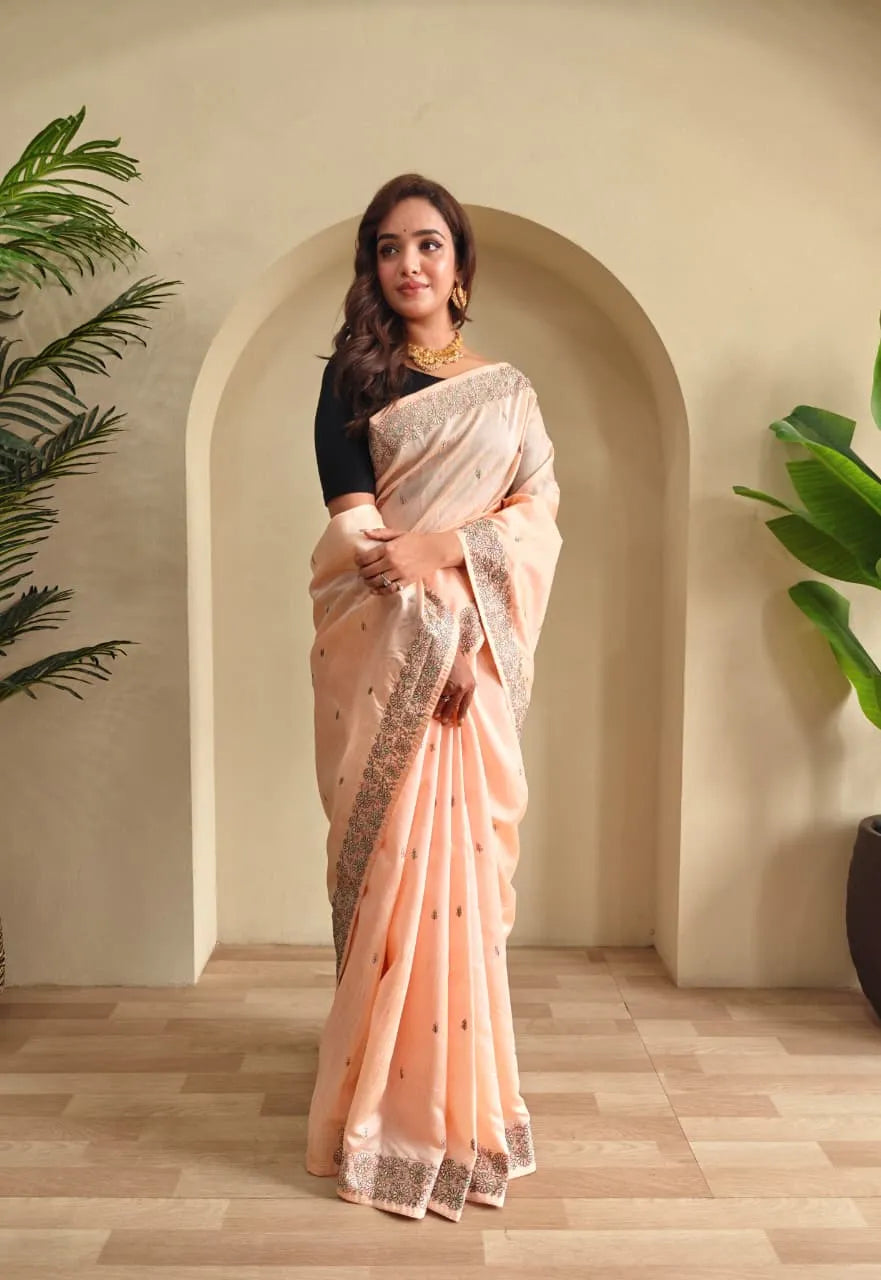 Woman wearing peach tussar saree with sequin border and black blouse in contemporary Indian style