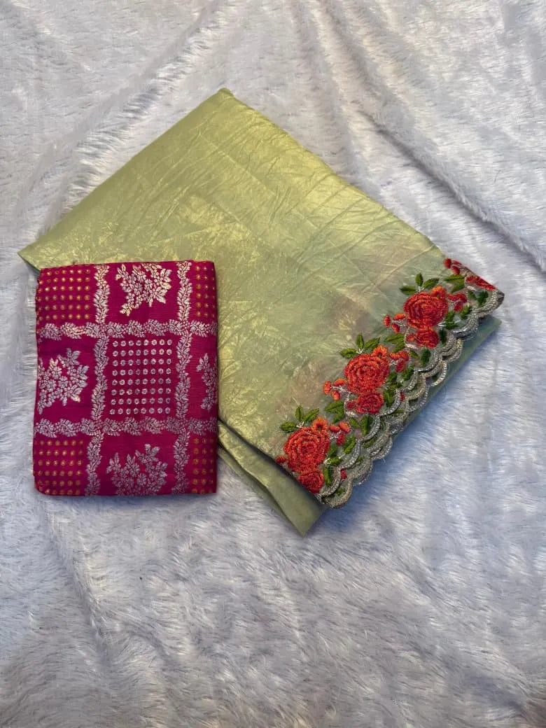 Pale yellow crunchy silk saree with red and orange rose embroidered border displayed on mannequin in saree shop