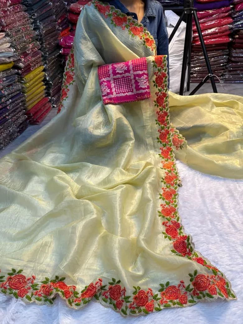 Yellow crunchy silk saree featuring colorful floral embroidered borders with rose motifs and scalloped edges