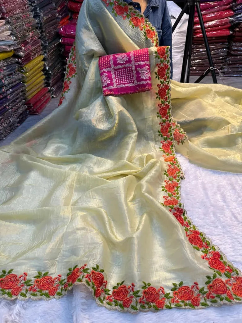 Yellow crunchy silk saree featuring colorful floral embroidered borders with rose motifs and scalloped edges