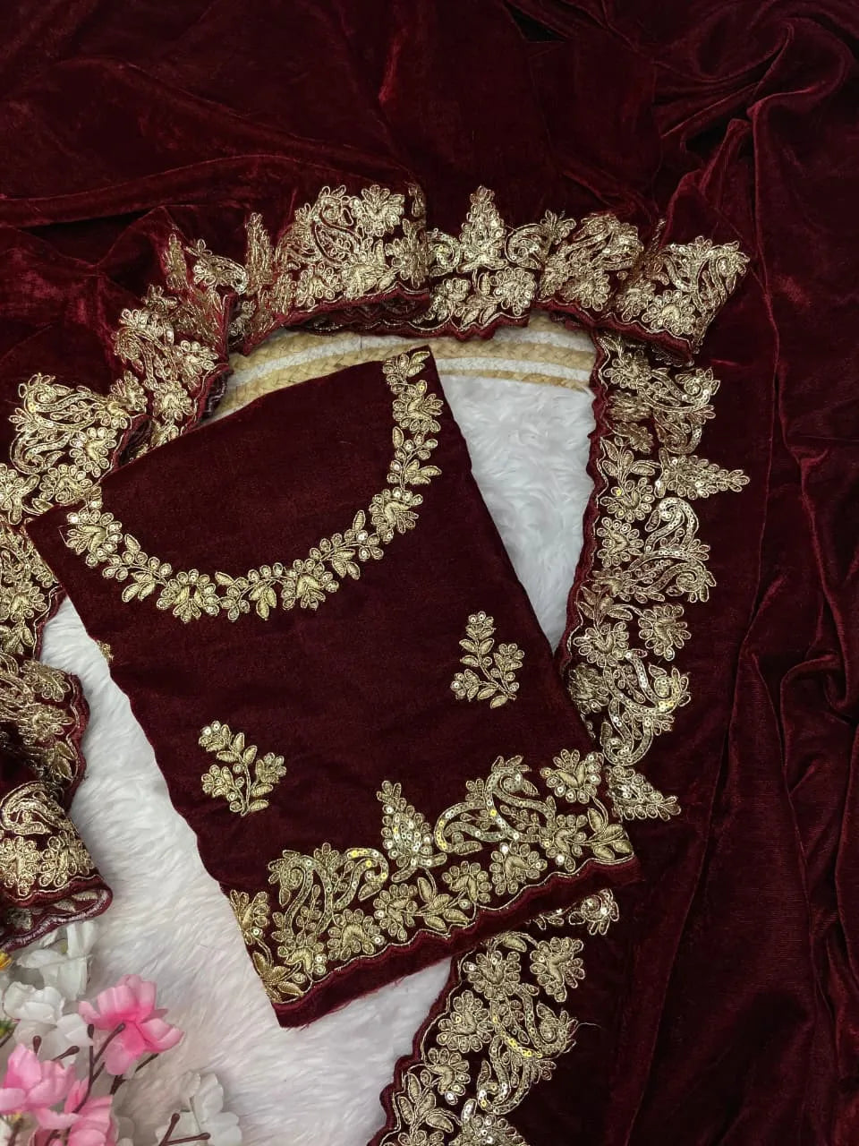 Maroon velvet celebrity style wedding saree featuring intricate gold zari work on borders and embellished three-quarter sleeve blouse