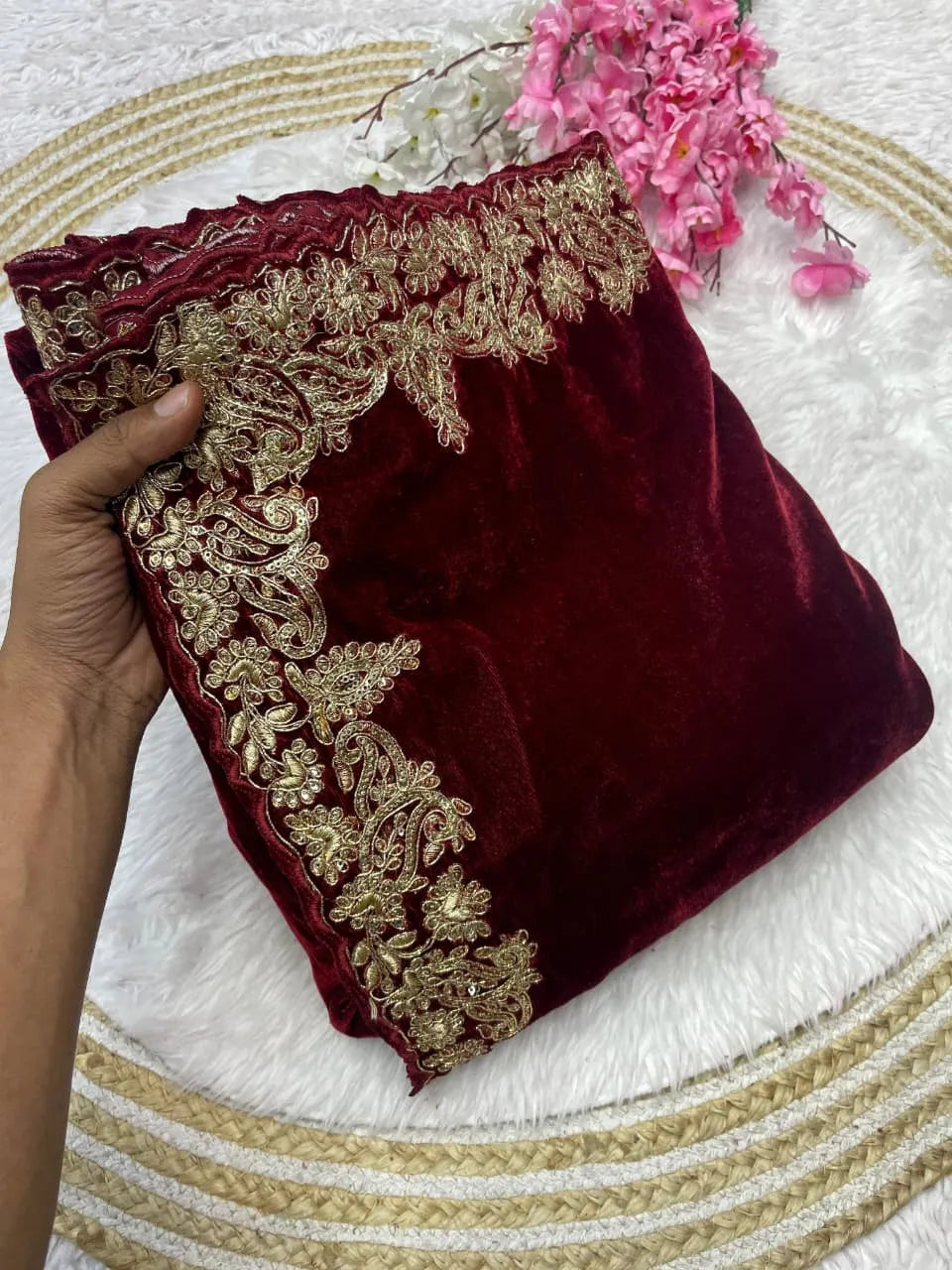 Maroon velvet celebrity style wedding saree featuring intricate gold zari work on borders and embellished three-quarter sleeve blouse