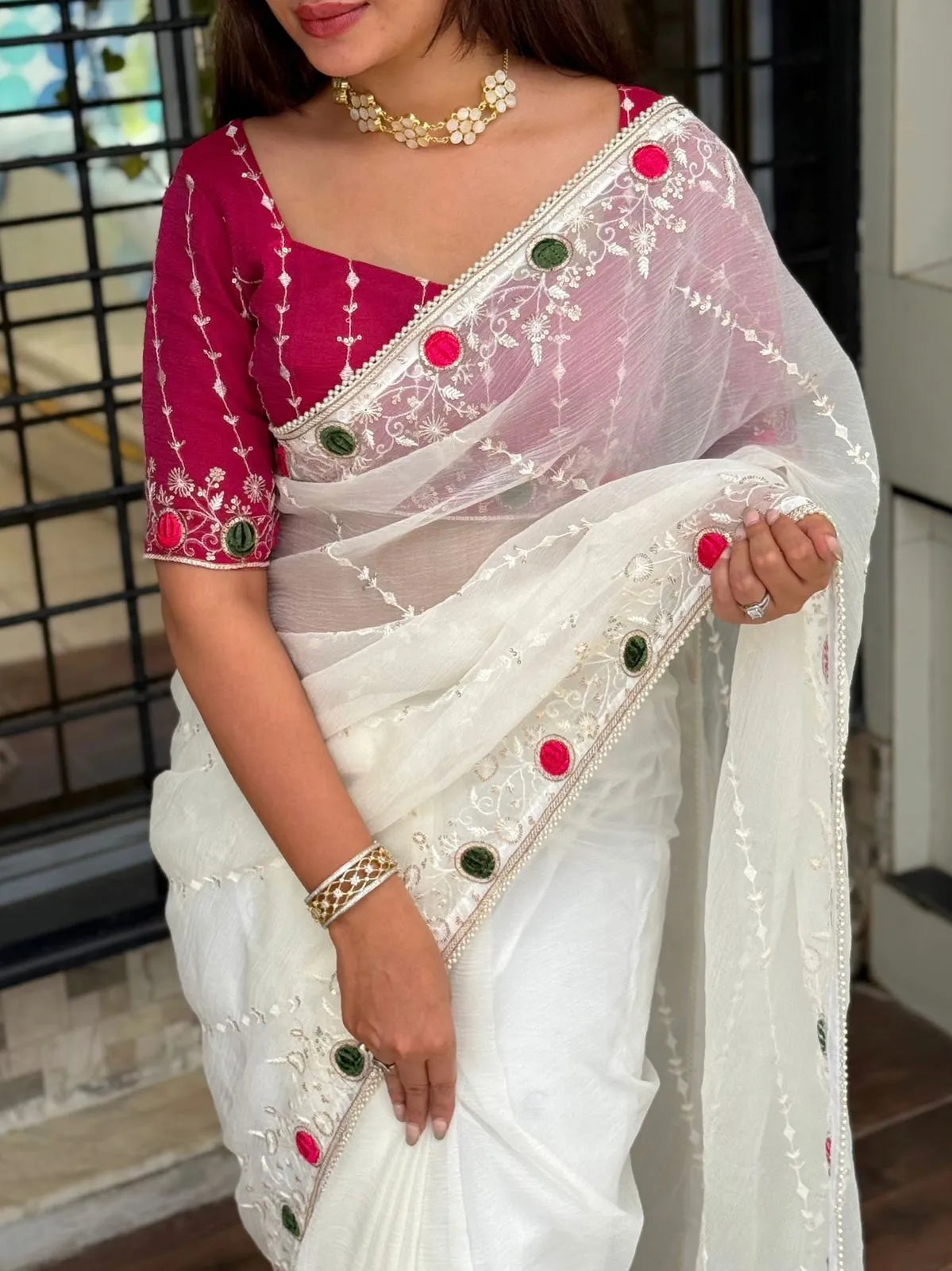 White crush saree with embroidered net overlay and designer magenta blouse featuring mirror work border