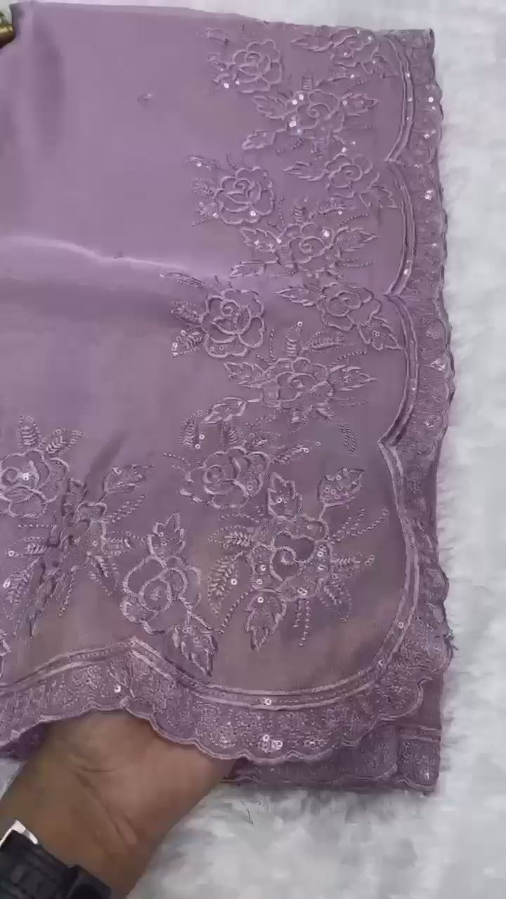 Elegant cream embroidered saree with floral lace border, paired with magenta blouse, ideal for festive and traditional occasions.