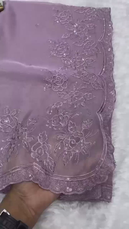 Elegant cream embroidered saree with floral lace border, paired with magenta blouse, ideal for festive and traditional occasions.